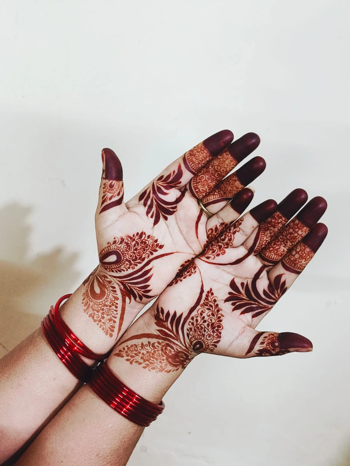 Mehndi on both hands with red bangles