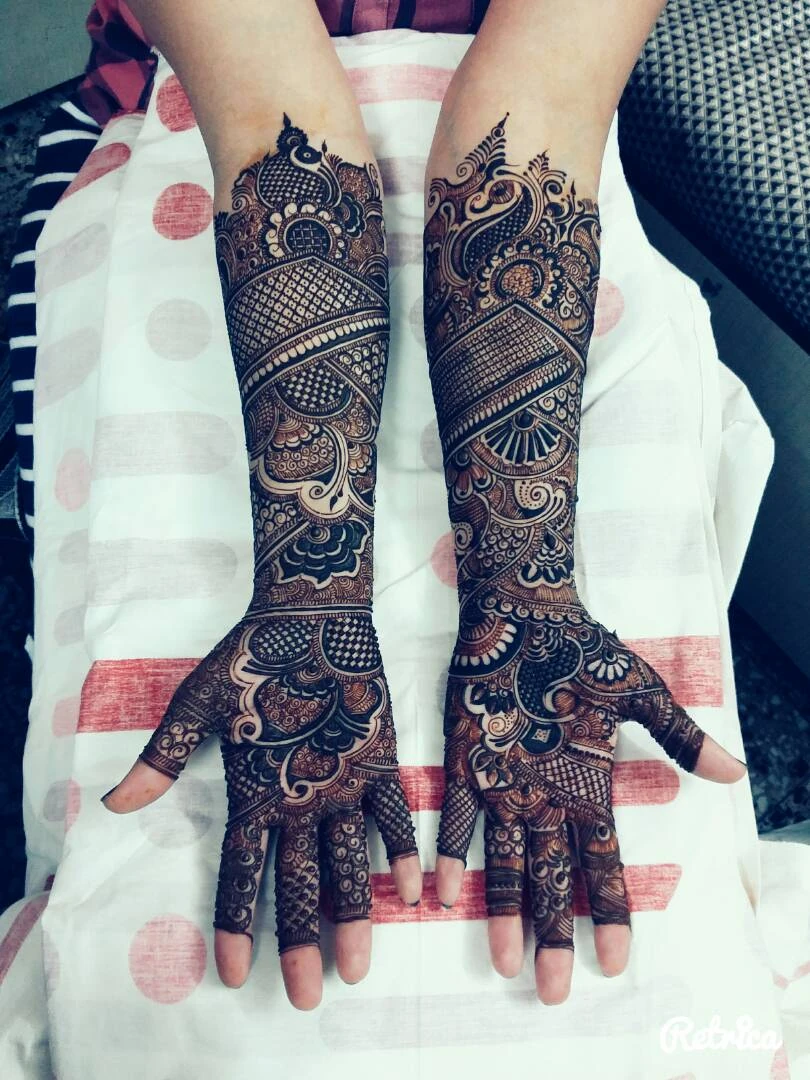 Dark traditional mehndi on both arms